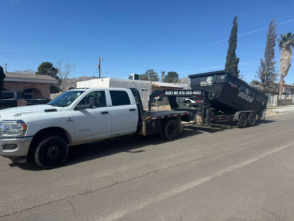 C&A Dumpsters heavy duty delivery truck picking up a load