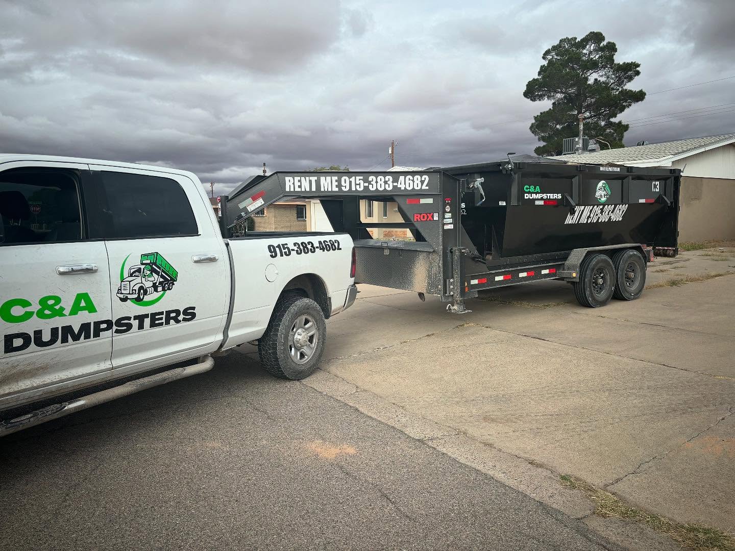 C&A Dumpsters truck delivering a roll-off bin