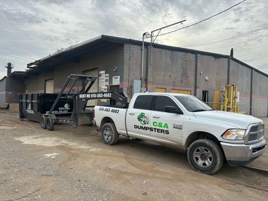 C&A Dumpsters heavy duty delivery truck at a commercial site