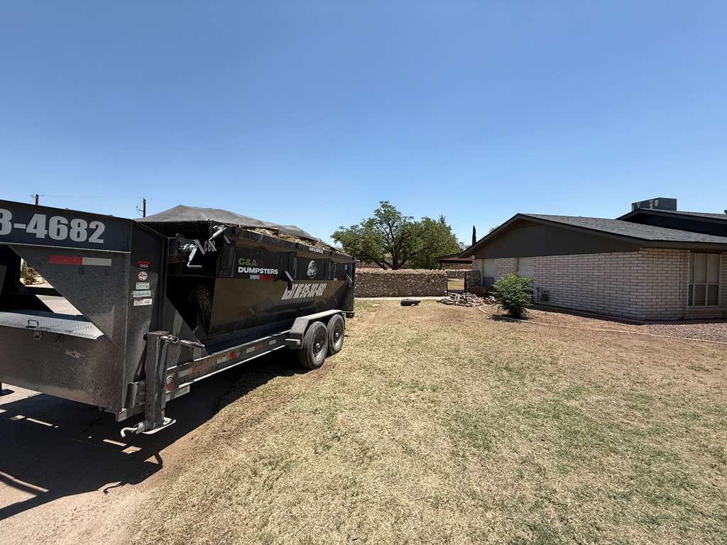 Dumpster delivered for backyard landscaping project